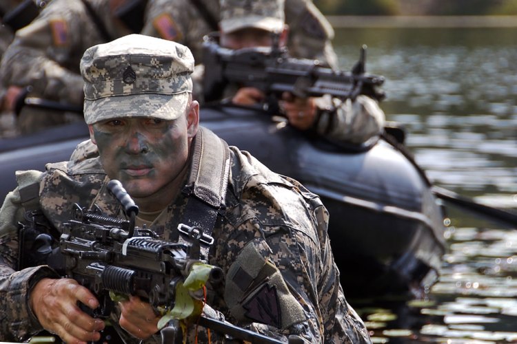 u-s-army-staff-sgt-james-gibson-scans-the-terrain-while-his-battle-buddies-keep-a-watchful-eye-from-the-water